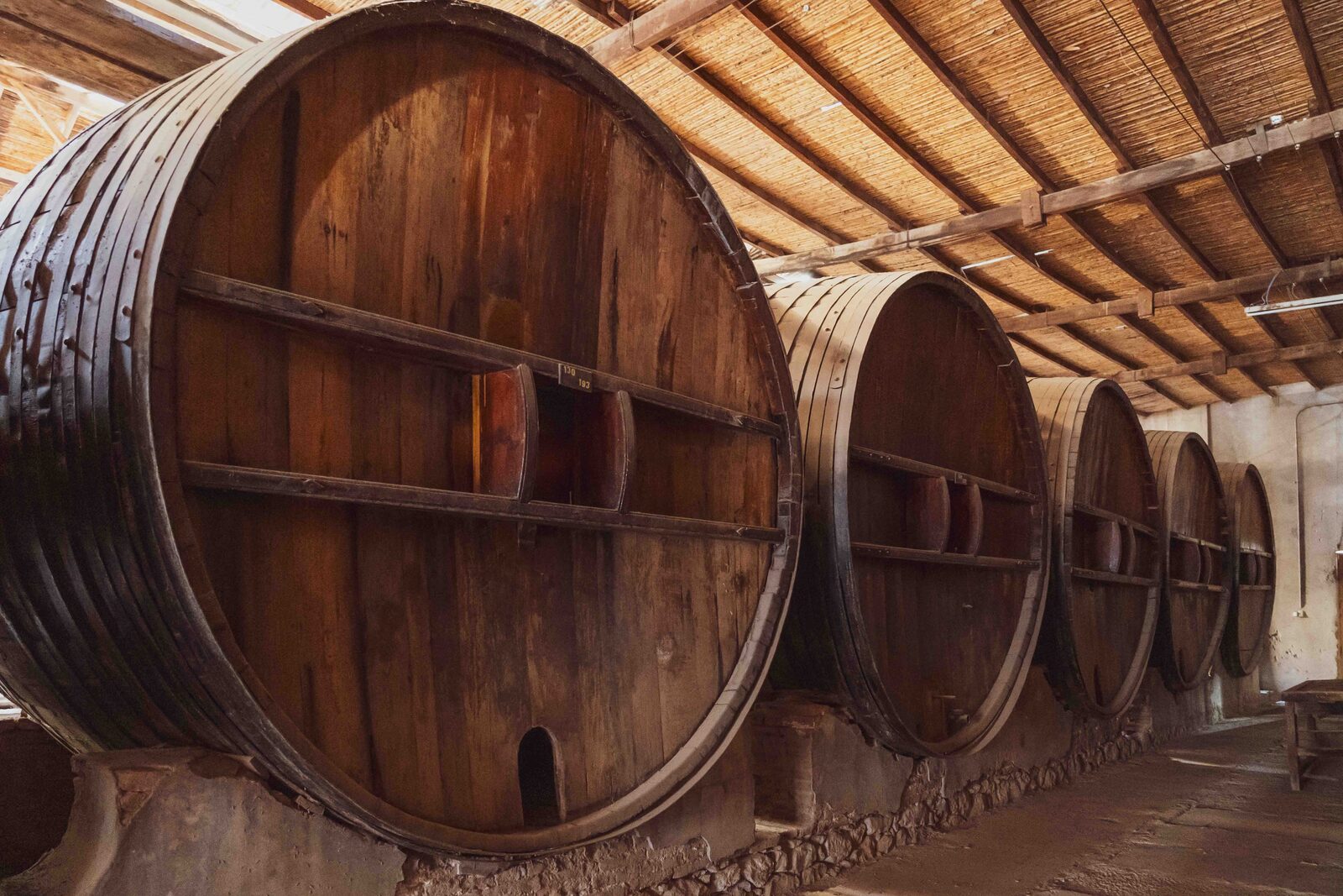 Oak barrels ageing wine in a Moroccan cellar